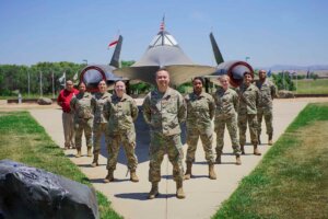 Airmen stand in a triangle